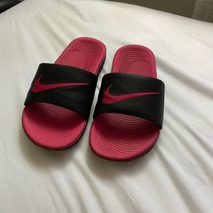 Pink and black Nike slides